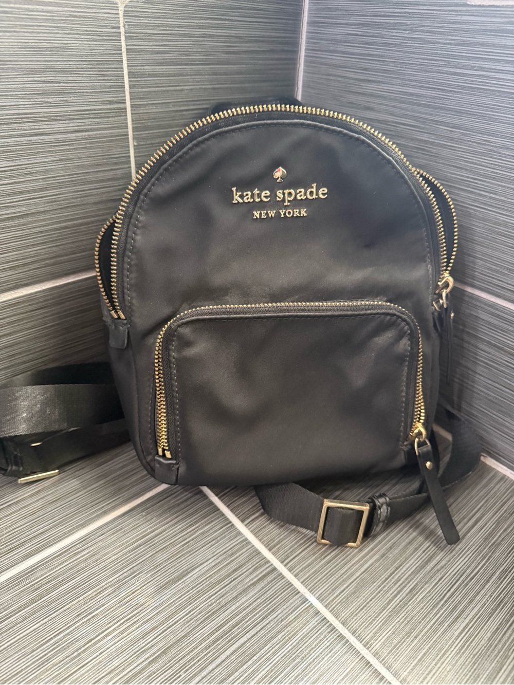 kate spade black nylon mini backpack with gold hardware and front zip pocket